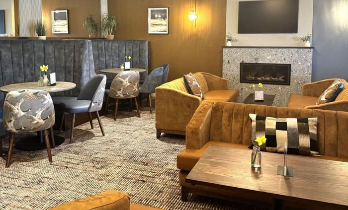 Flat Rock Lounge space with 4 booths, a gas fire and 2 tables with lounge sofas